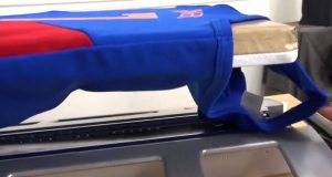 a blue jersey threaded onto a heat press platen